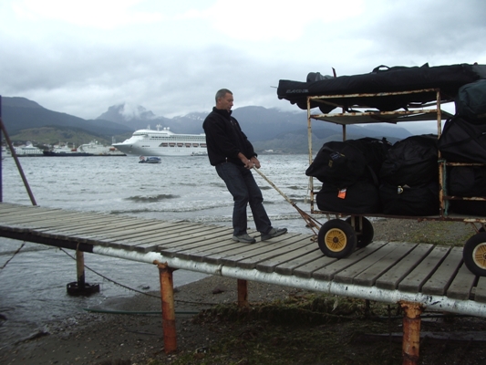 Image: Andrew Wall a.k.a. Arnie drags a load of climbing gear towards the boat